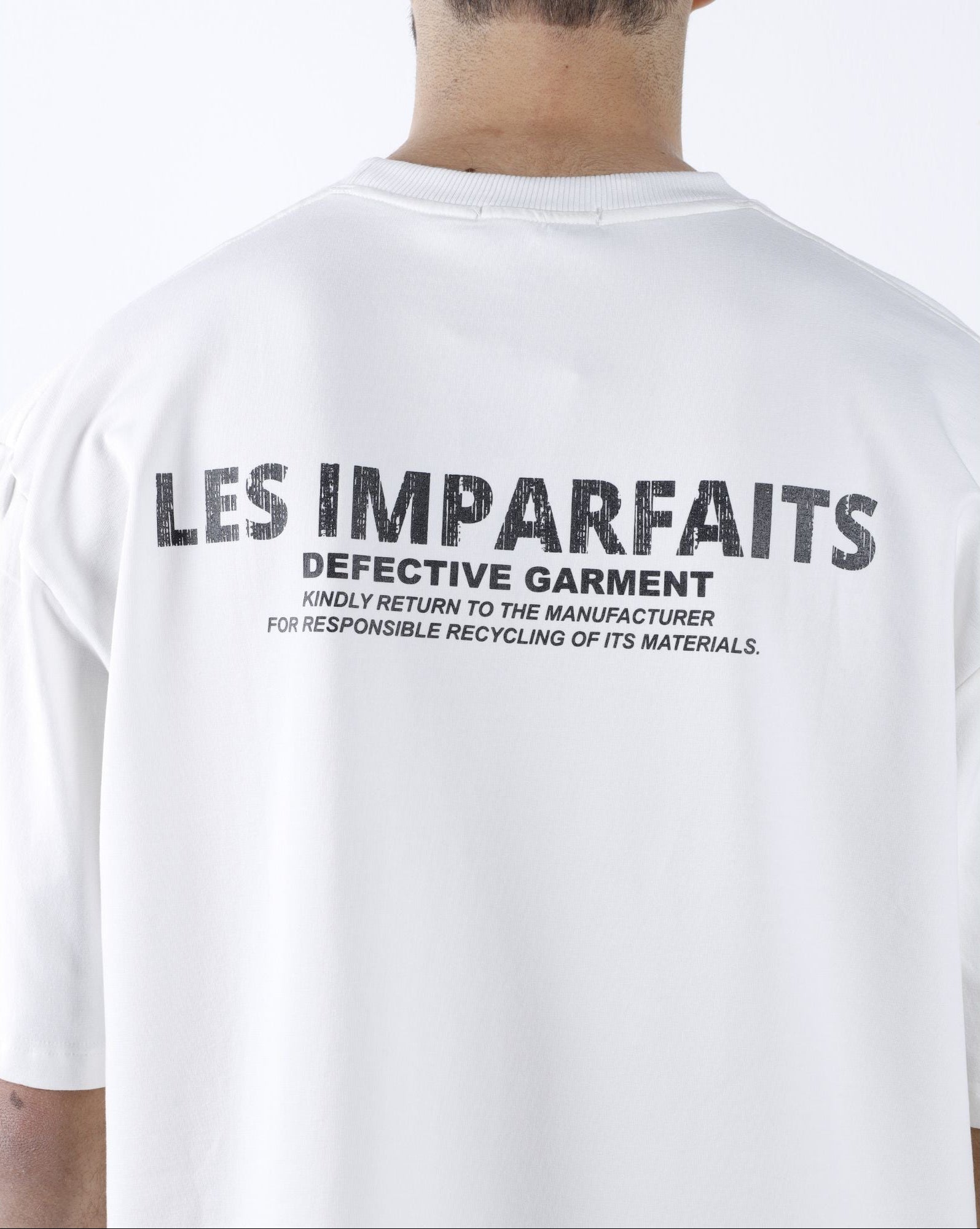 White "Defective Garment"  T-Shirt