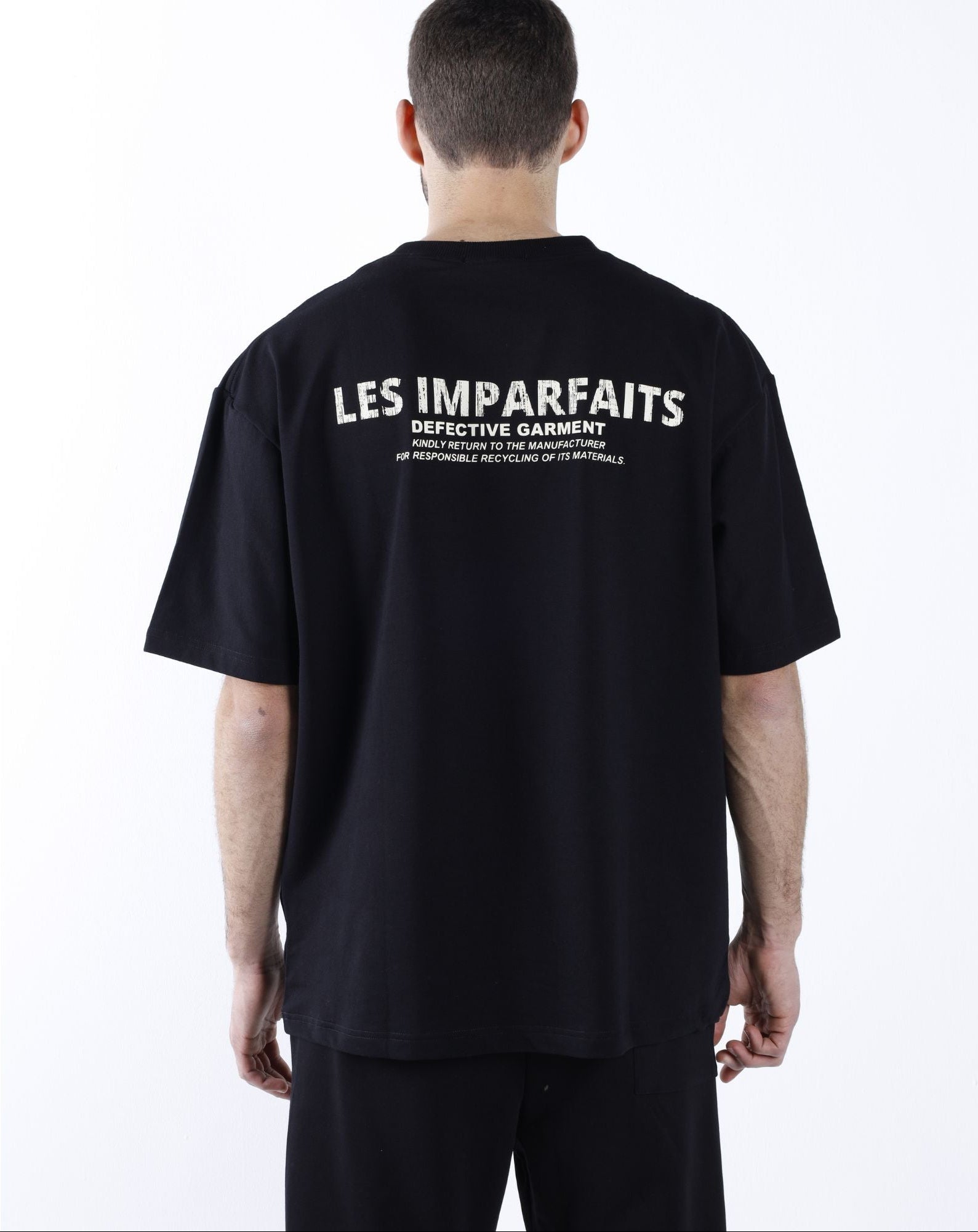 Black "Defective Garment"  T-Shirt